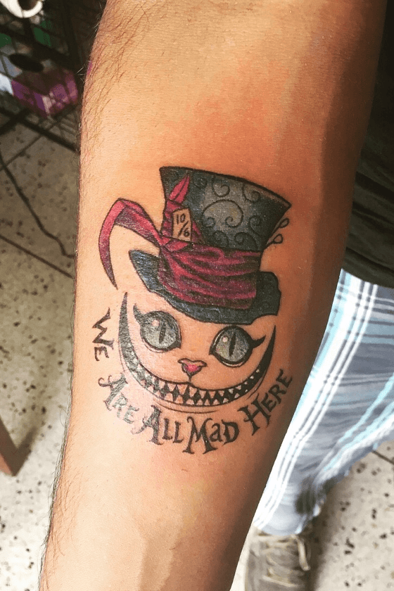 quotWe39re All Mad Herequot is a popular lettering from Alice in  Wonderland fairy tale Color Black Tags C  Cheshire cat tattoo Tattoo  designs Tattoos