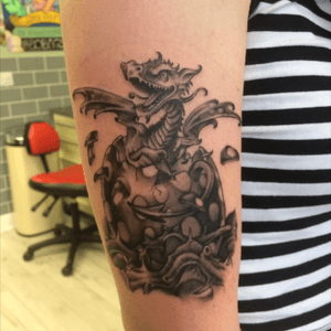 Baby dragon tattoo, design is an illustration from a book owned by the client