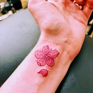 Pink UV ink cherry blossom.  Done by @tigereyes at 4Points Body Gallery in S Minneapolis. #uv #uvtattoo #UVtatoo #uvtattoos  #cherryblossom #wristtattoo #tinytattoo #girlswithtattoos 