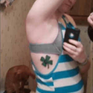 Shit photo but its a shamrock with the letter D in the middle. First tattoo done by brother. 2011 age 17