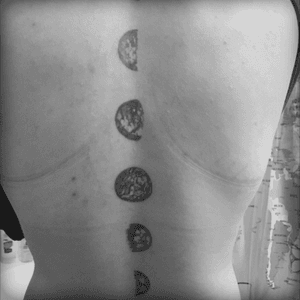 Phases of the moon, spine tattoo
