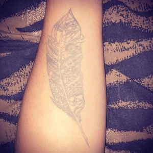 Grey ink dreamcatcher feather tattoo 