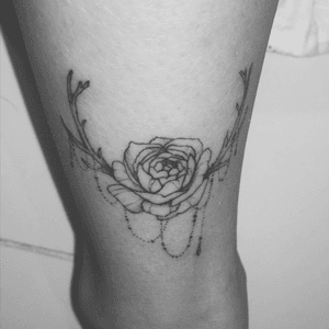 Rose with antlers tattooed by Mae Oh
