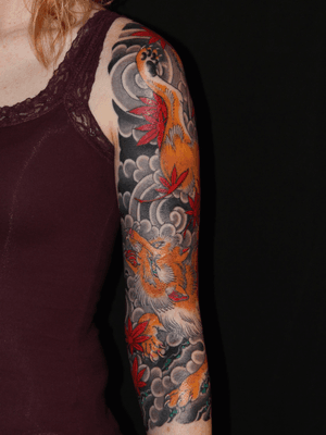 Experience the mystical allure of a fox spirit with this stunning Japanese kitsune tattoo. Expertly crafted by renowned artist Stewart Robson.