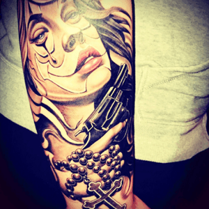 First tattoo in love 😍#chicano #forearm #gun #cross #roserybeads 
