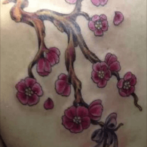 I love cherry blossoms. I added a bell to the bottom for my daughter Annabelle. Im hoping to add 3 more images for my 3 sons; a cherub, a hummingbird and a moth. I had this done at Skin Decor in Fresno CA. Artist was the shops owner, Jim McQuaid. 