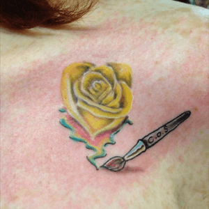 6th tattoo. Done in 2014. Yellow rose for my mom who had recently passed, my brother who passed as an infant, and my husbands maternal grandfather. He was a billboard painter. Thats why ithe rose puddles down like paint and on the paint briah is the letters C.O.S. Which was granpas favorote saying, crock of shit!!