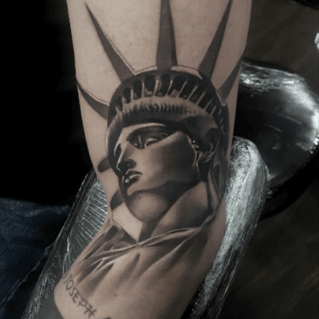 Black And Grey Statue Of Liberty Tattoo On Right Forearm