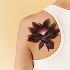 By far one of my favorite tattoos #lily #glow #flower #shouldertattoo #dark #petals #blooming 