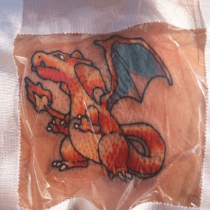 This was my first tattoo and i wanted a dragon at the time but not too manly at the time so o got a cute charizard instead.