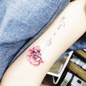 No clue what that says, but its so pretty! Delicate. #flower #delicate #script #quotetattoo 