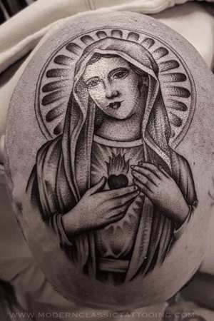 Classic black and gray design of Mother Mary on face in London, GB. A powerful and spiritual choice for your ink.