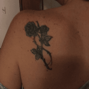 Blue roses with barbed wire on the left shoulder