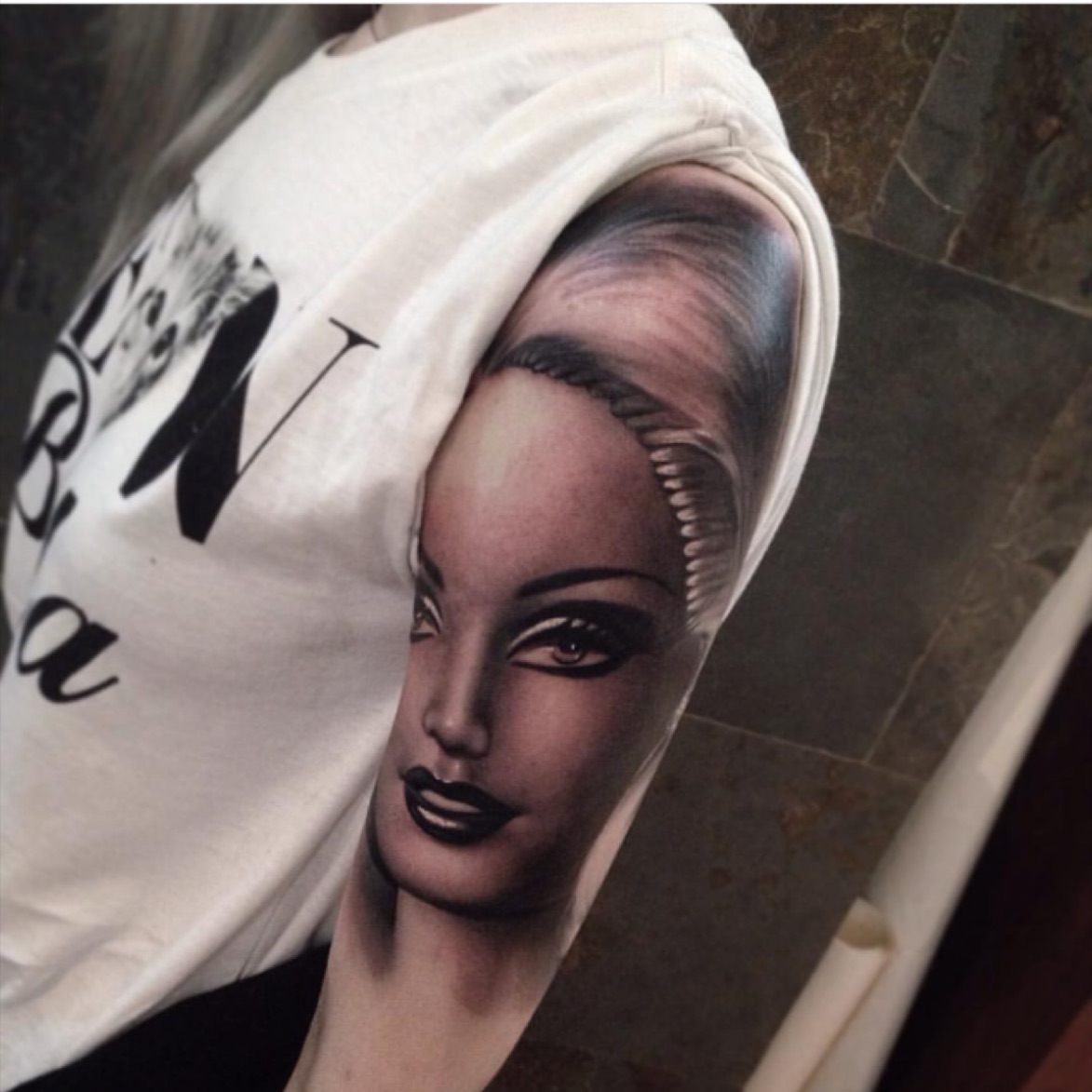 Black and grey Barbie tattoo on the inner forearm