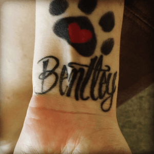 My first tattoo was the dog paw i got done for my dog  then my Second tattoo i got was his name bentley.