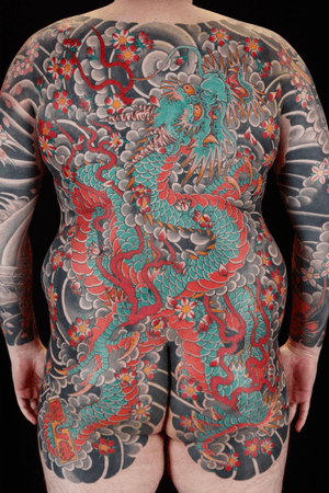 Exquisite body suit featuring a powerful dragon intertwined with delicate sakura cherry blossoms, by renowned artist Stewart Robson.