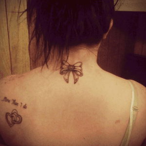 The bow I got with my mother and sister. The double hearts and saying I got matching tattoos with my husband. 