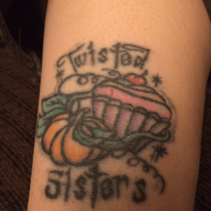 Twisted Sisters with a pumpkin holding a cupcake                                tattoo is for my stepsister, she calls me Pumpkin, I call her Cupcake
