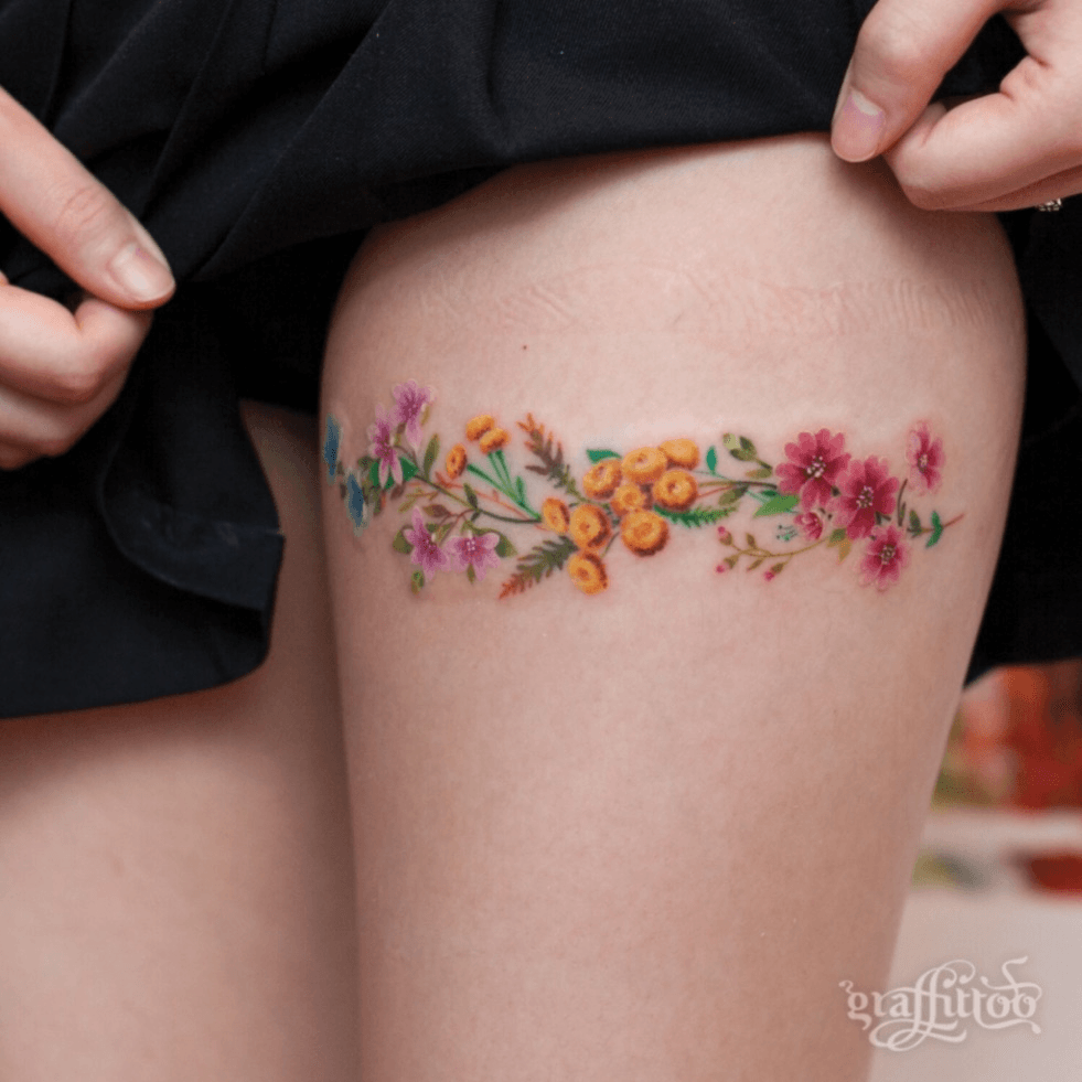 Illustrative style lotus flower tattoo on the left
