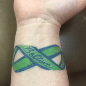 It's a ribbon that says believe on my right wrist. It is in an infinity symbol for BFRB and saying how i will overcome it and be stronger. This is my first tattoo.