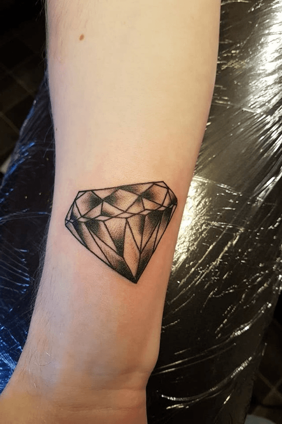 Minimalist diamond tattoo on wrist