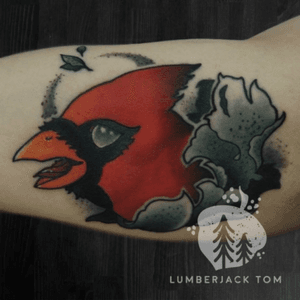 Cardinal and scrollwork on the inner bicep