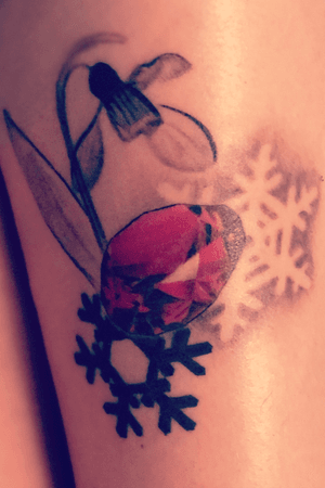 January tattoo. Snow drop flowers, garnet, and snowflakes. This sweet tatt is my 11th tattoo. Derek at Level Up tattoo did this for me for my birthday! 