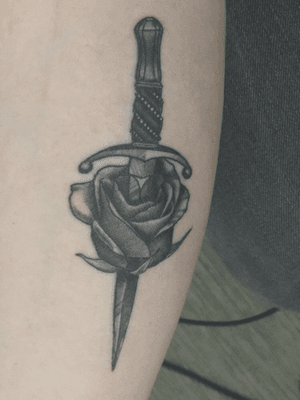 rose pierced by a dagger #blackwork #blackandgrey #fineline #rose #dagger #sad #strength #arm #first #firsttattoo 