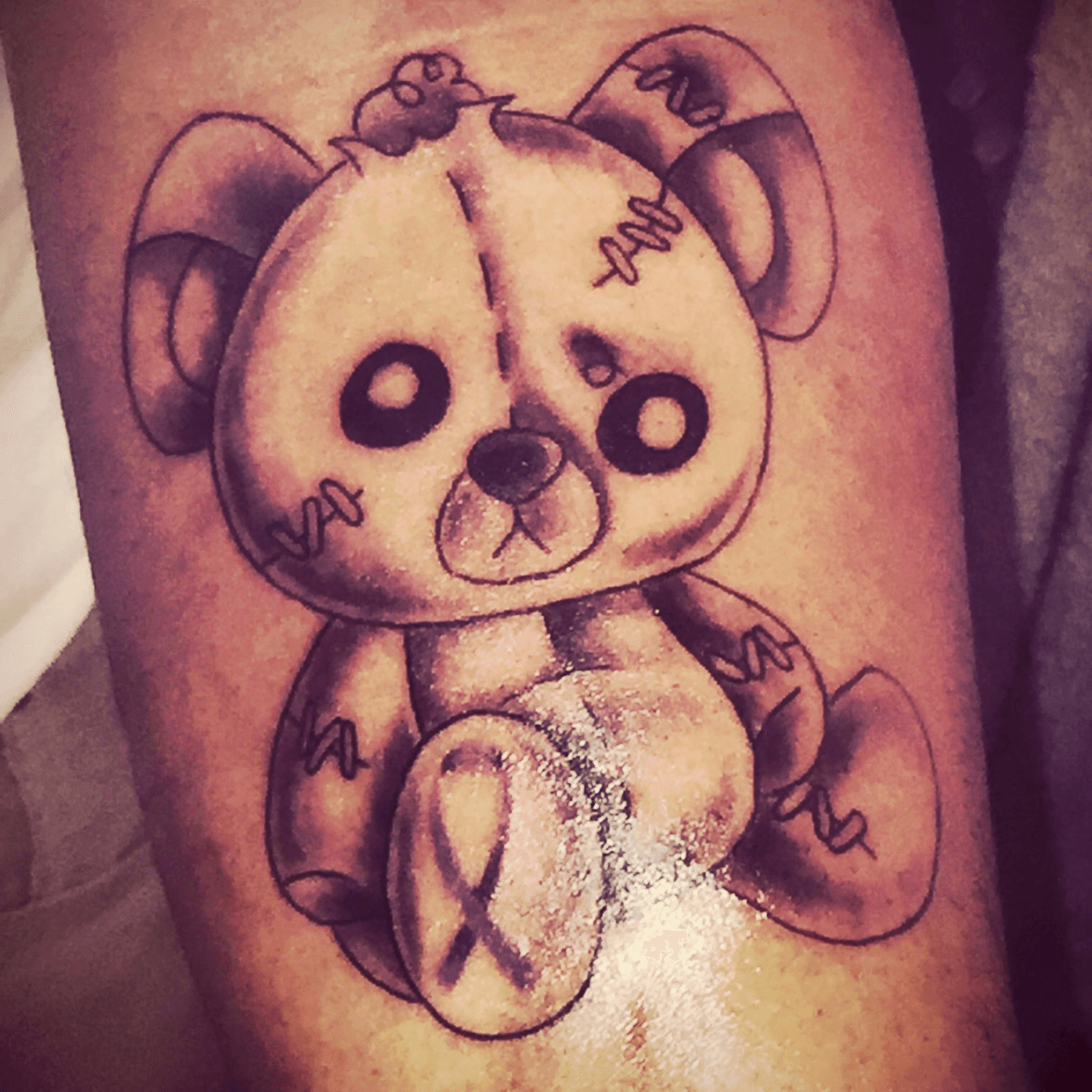 broken teddy bear tattoo