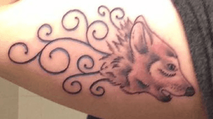 Wolf tattoo on right tricep