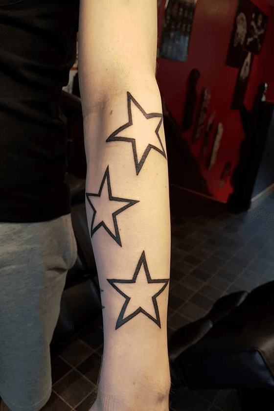 Colored Star Tattoos On Left Forearm