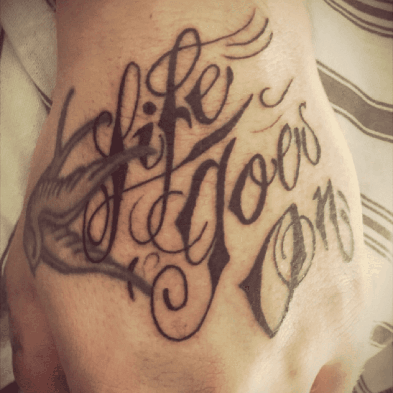 Tattoo uploaded by Get InkD by MANAV HUDDA  Lettering Tattoo Life goes on  manavhudda getinked getinkd letteringtattoo handtattoo tattooideas   Tattoodo