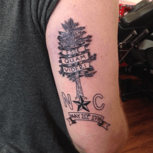 North Carolina tribute piece incorporating the state motto, state tree, and elements of the state flag. By Ryan Mistretta at Phoenix Tattoo, Raleigh, NC.