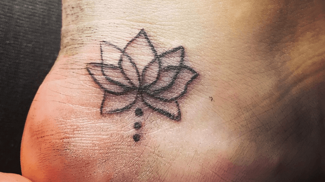 small lotus flower foot tattoos