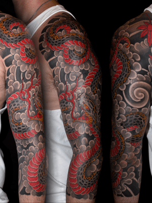 Explore the intricate beauty of a Japanese snake motif expertly inked on your sleeve by renowned artist Stewart Robson.