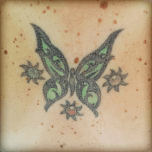 My very first tattoo. The butterfly symbolizes me and the other tnree are suns because I have three sons and the centers are their birthstone colors. This one is ten yrs old now and I think I need it revamped 
