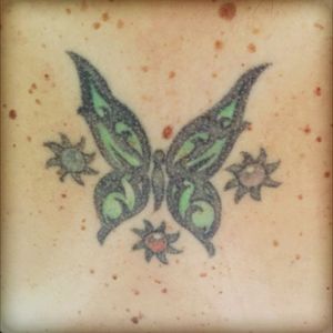 My very first tattoo. The butterfly symbolizes me and the other tnree are suns because I have three sons and the centers are their birthstone colors. This one is ten yrs old now and I think I need it revamped 