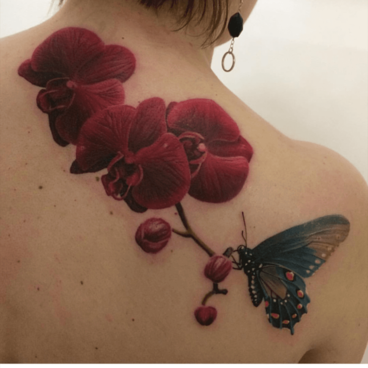 orchid and butterfly tattoo by Blaze Schwaller TattooNOW