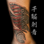 Automotive ripped skin cover up of text. Tattooed by Oliver Wong