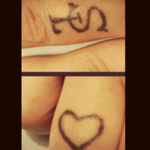 Left and right ring finger. Not the best tattoo's. The heart is for the missing love in my life. The SL is my kids, Sara and Lucas. 