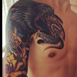 A blue and purple phoenix over chest and shoulder, above a pink and yellow lotis flower. The beginning of a sleeve!