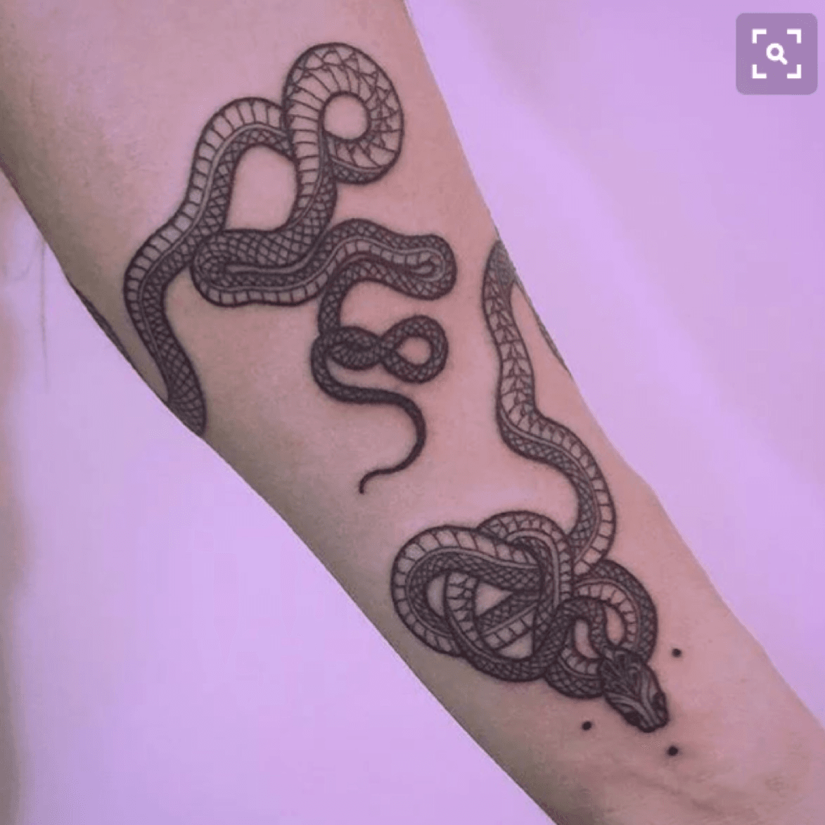 Large snake tattoo located on the thigh