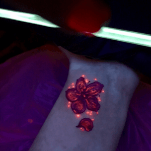 Pink UV ink cherry blossom tattoo.  Done by @tigereyes at 4Points Body Gallery in S Minneapolis.  #uv #uvtattoo #UVtattoo #wristtattoo #tinytattoo #girlswithtattoos 