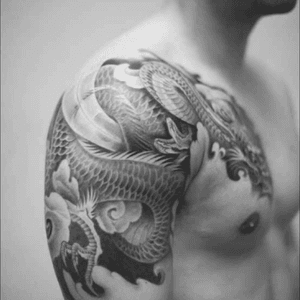 Amazing black and grey dragon design over the shoulder onto the chest #dreamtattoo