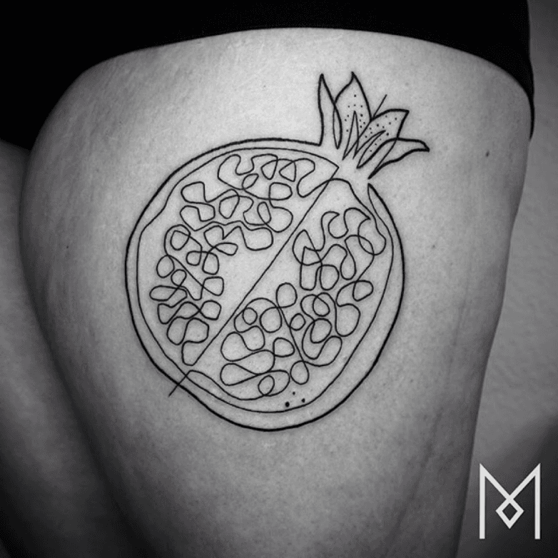 Minimalistic fine line pomegranate tattoo located on