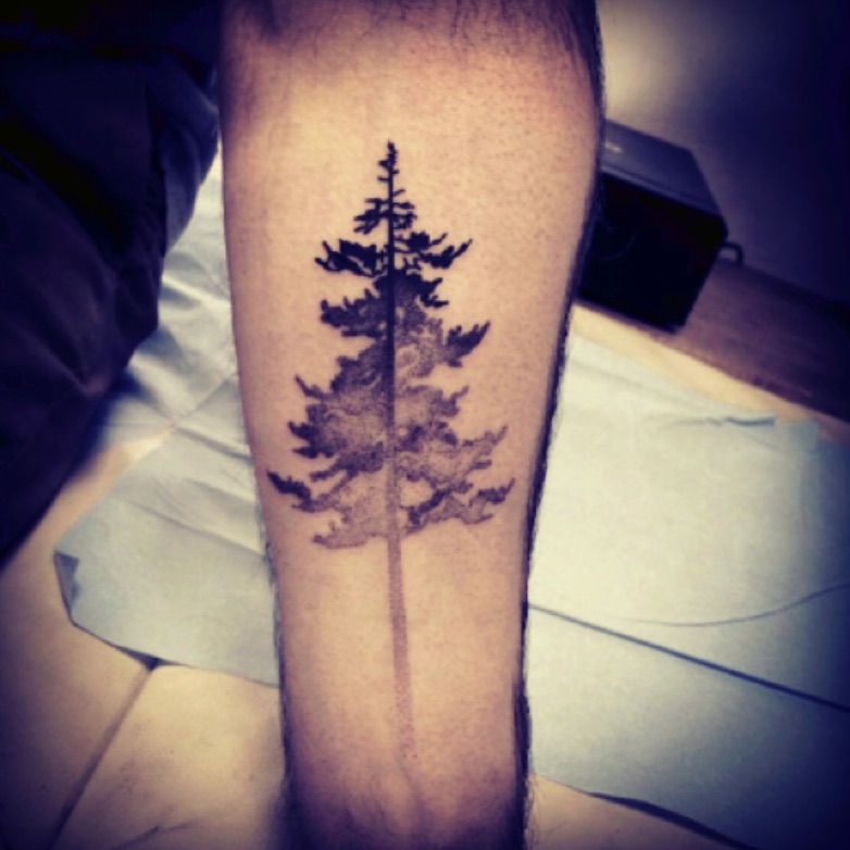 Hand poked pine tree tattoo on the wrist.