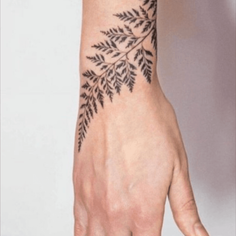 Fine line leaves tattoo on the wrist