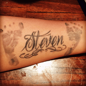 My first son name with his new born feet. My very first tattoo I had got.