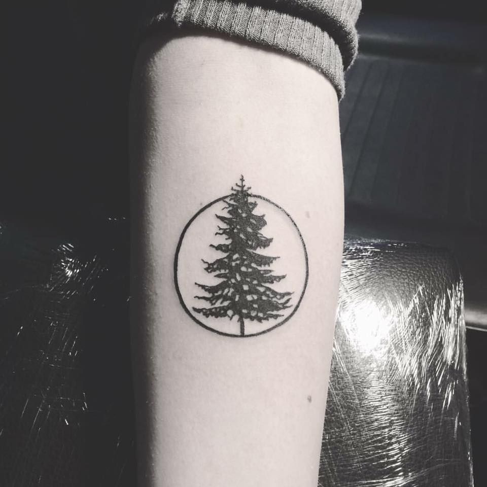 Minimalistic Christmas tree tattoo located on the