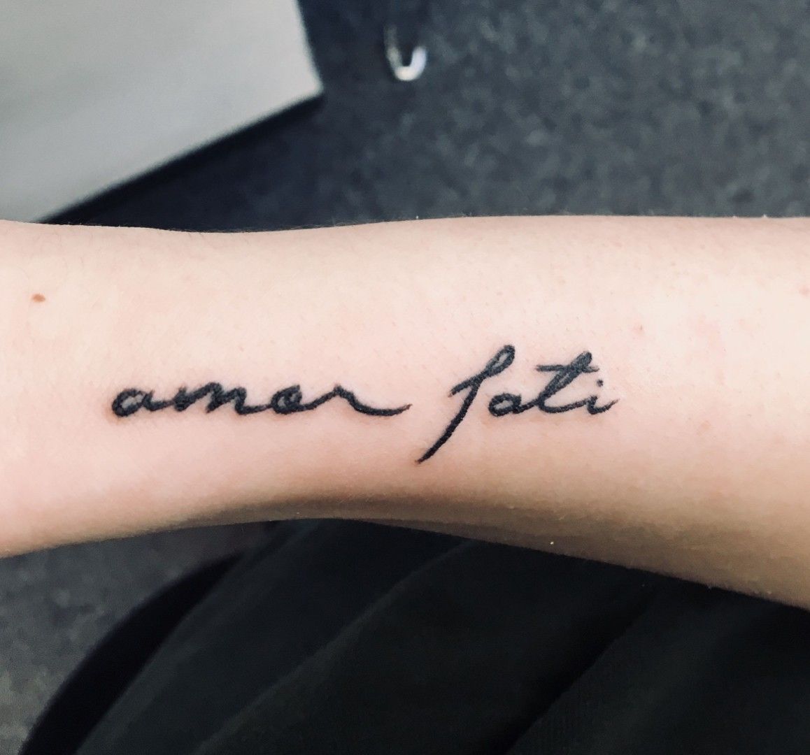 Tattoo that says amor fati hand poked on the forearm